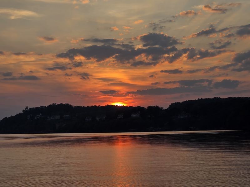 Sunset behind lake homes on the bluff